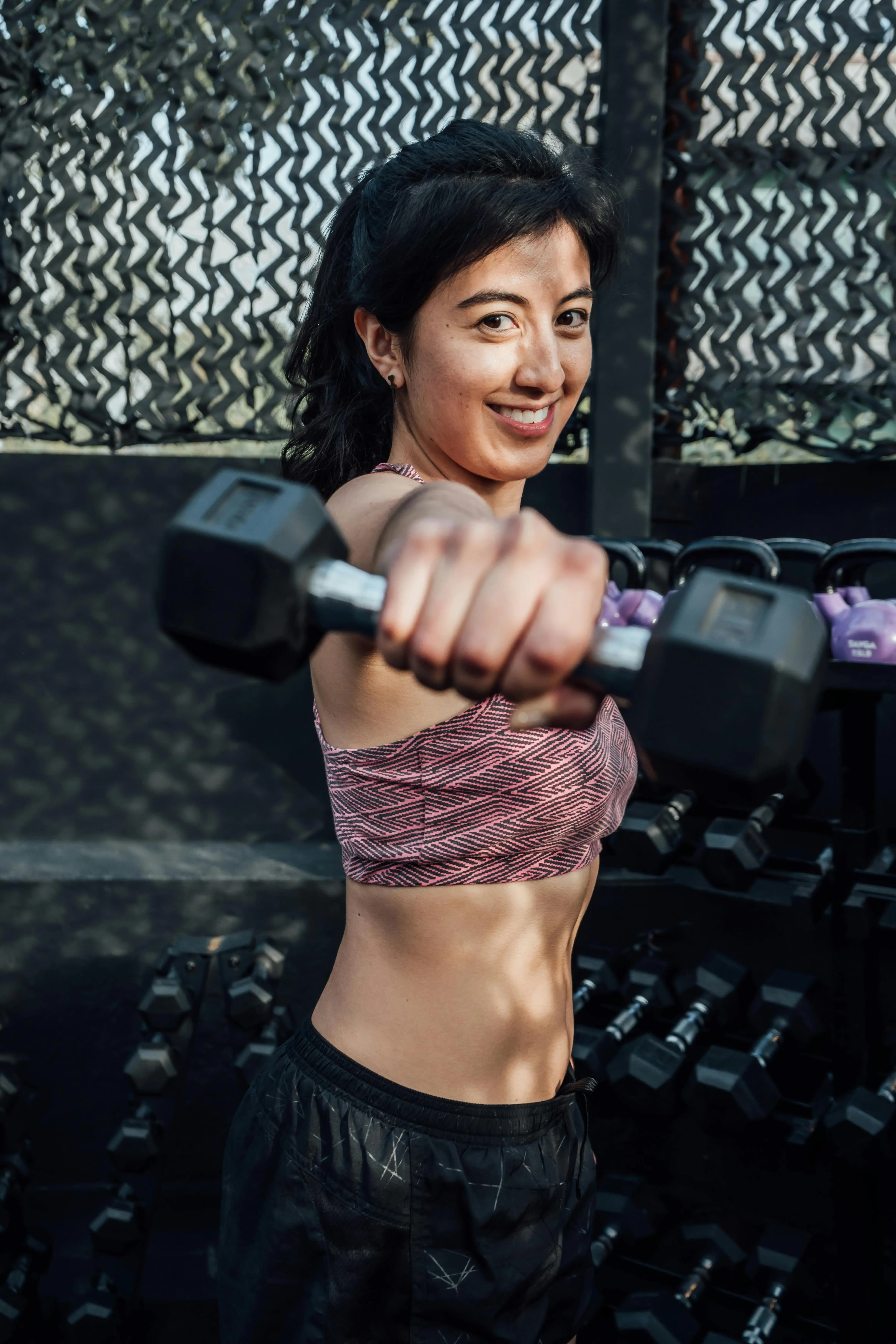 Portrait of a woman holding a dumbbell